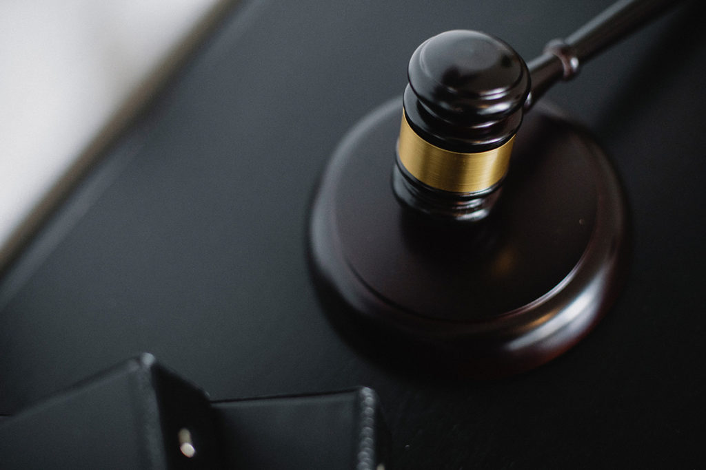 Courtroom gavel resting on a sound block