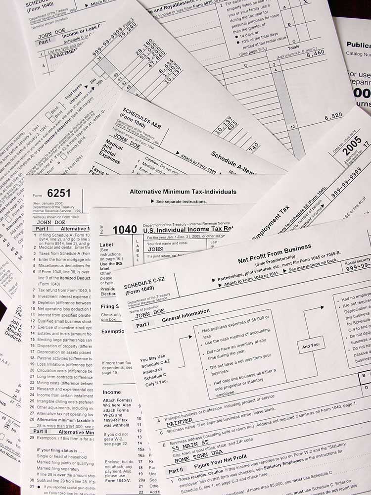 pile of tax forms spread out on table