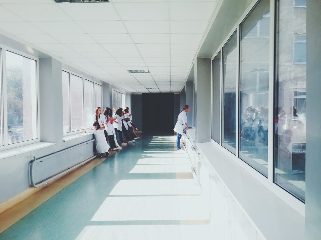 A group of medical workers standing in the corridor of a hospital