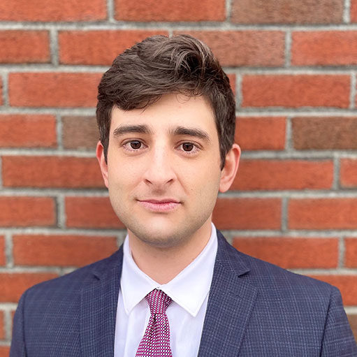 Headshot of Cosmo Karlolos, Associate at D'Ambrosio