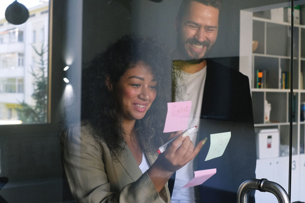 Couple looking at Post It notes as they talk about their estate plan